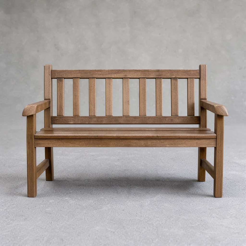 A slatted wooden bench against a plain grey wall