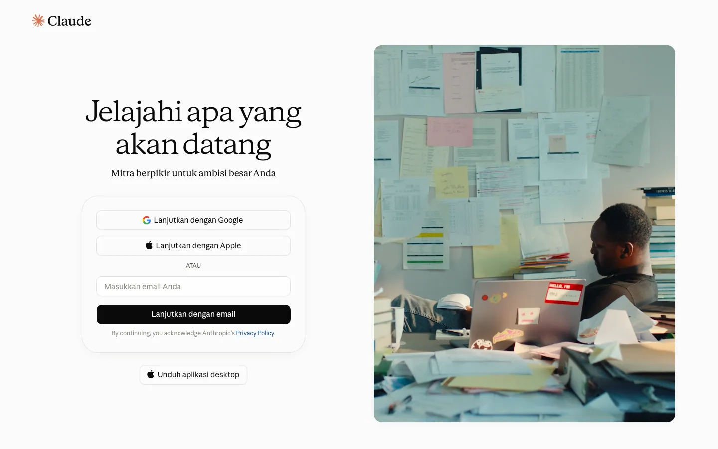 Halaman masuk claude.ai versi Bahasa Indonesia: judul "Jelajahi apa yang akan datang", tombol Lanjutkan dengan Google, Lanjutkan dengan Apple, kolom email, dan tombol Unduh aplikasi desktop, dengan foto ruang kerja di sisi kanan